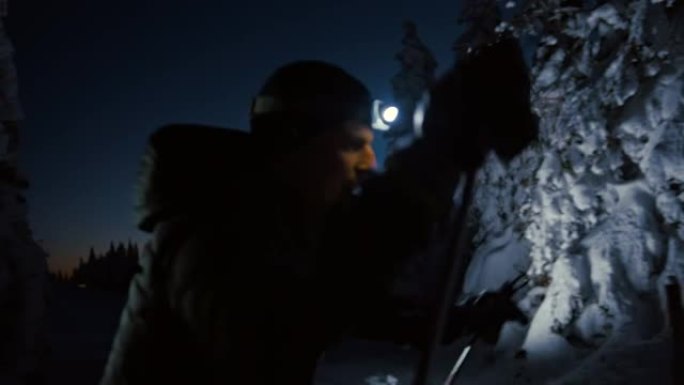 SLO MO两名男子越野滑雪运动员在夜间用大灯滑雪