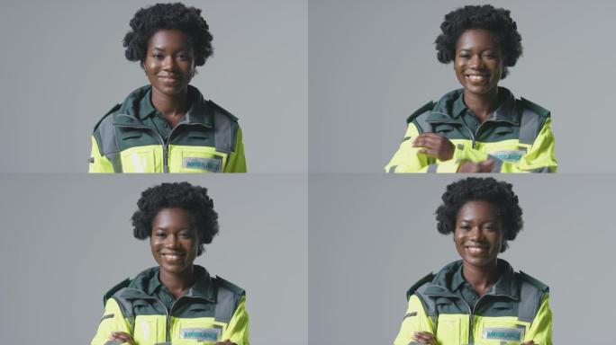 工作室肖像的微笑的年轻女性护理人员在朴素的背景下穿着制服