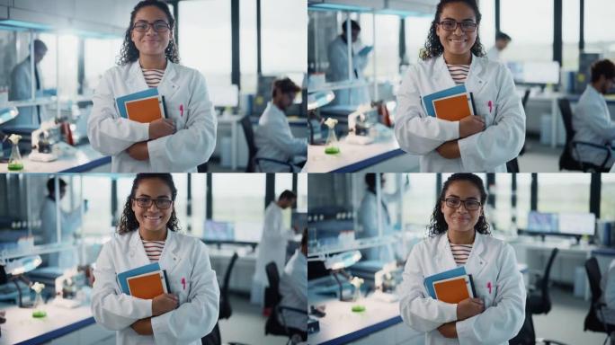 医学科学实验室: 美丽聪明的年轻黑人科学家，穿着白色外套和眼镜，拿着测试书籍，微笑着看着相机。多元化