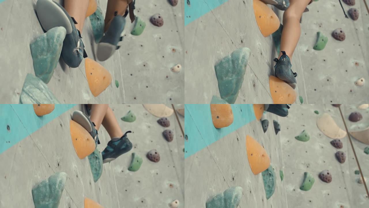 在攀岩鞋中穿鞋的特写镜头克服攀岩墙上的障碍物，慢动作