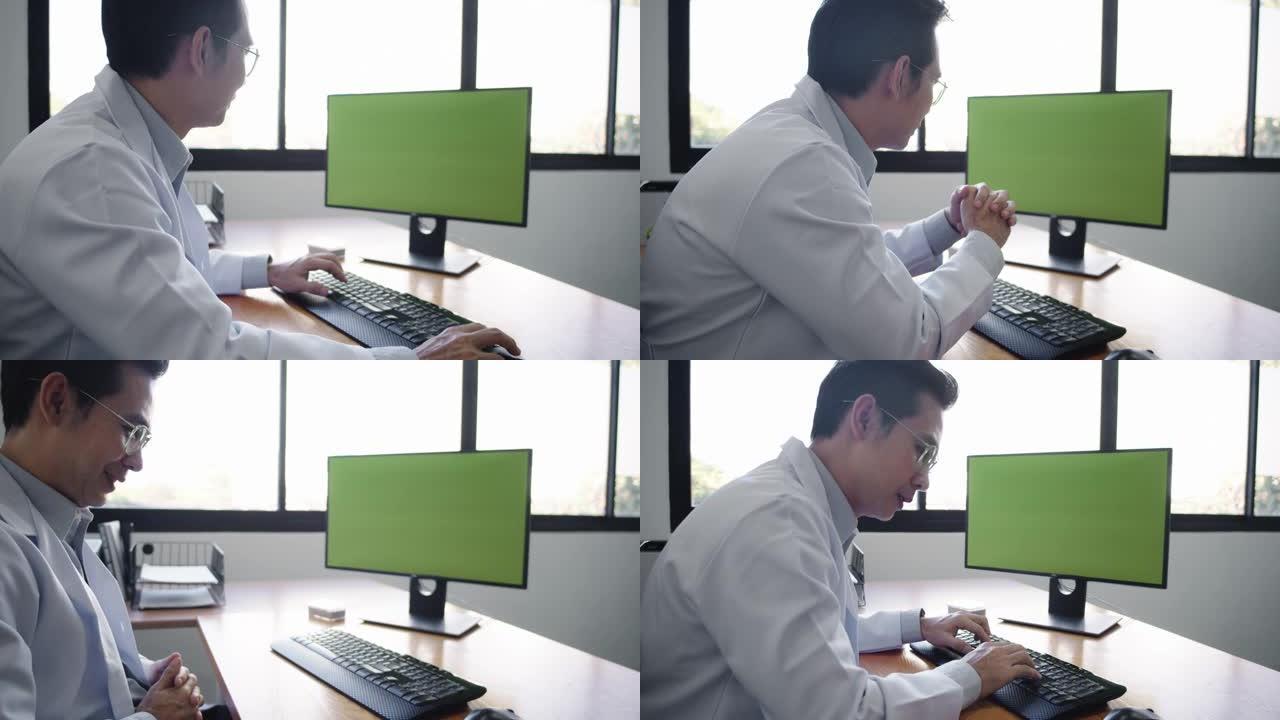 亚洲男子医生在电脑上工作。