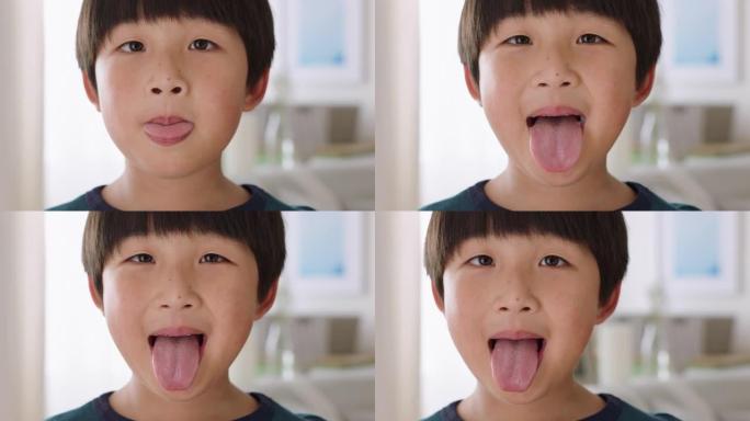 肖像快乐的亚洲小男孩伸出舌头淘气的孩子玩乐地做鬼脸4k镜头