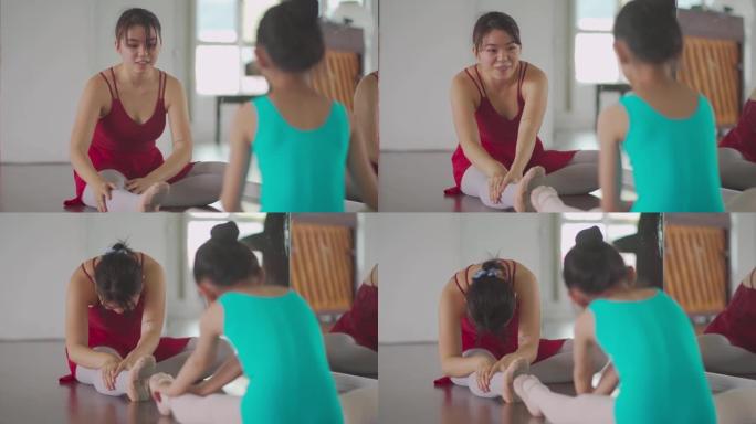 亚洲中国少女芭蕾舞演员在工作室训练她的年轻女学生热身运动
