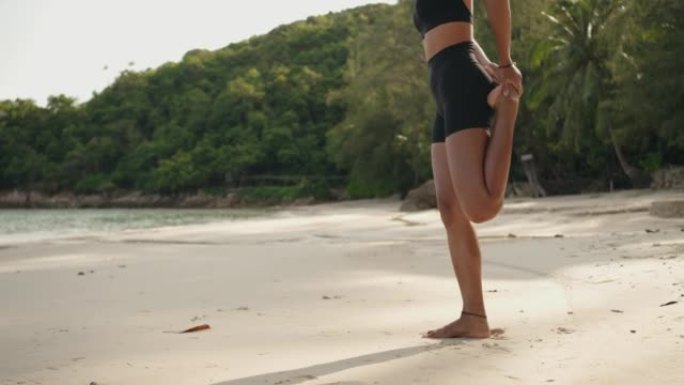 女人在海滩上锻炼女孩沙滩上做拉伸运动