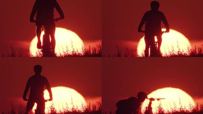 日落时骑自行车的人举起自行车的剪影