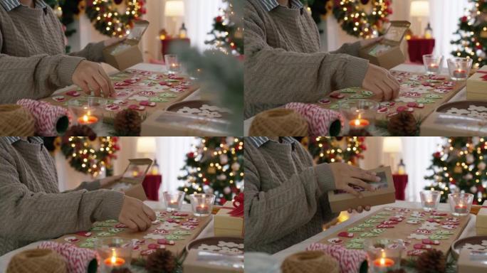为圣诞礼物准备彩色姜人皇家糖衣饼干。