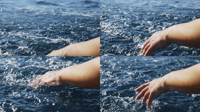 SLO MO年轻女子的手触及海面