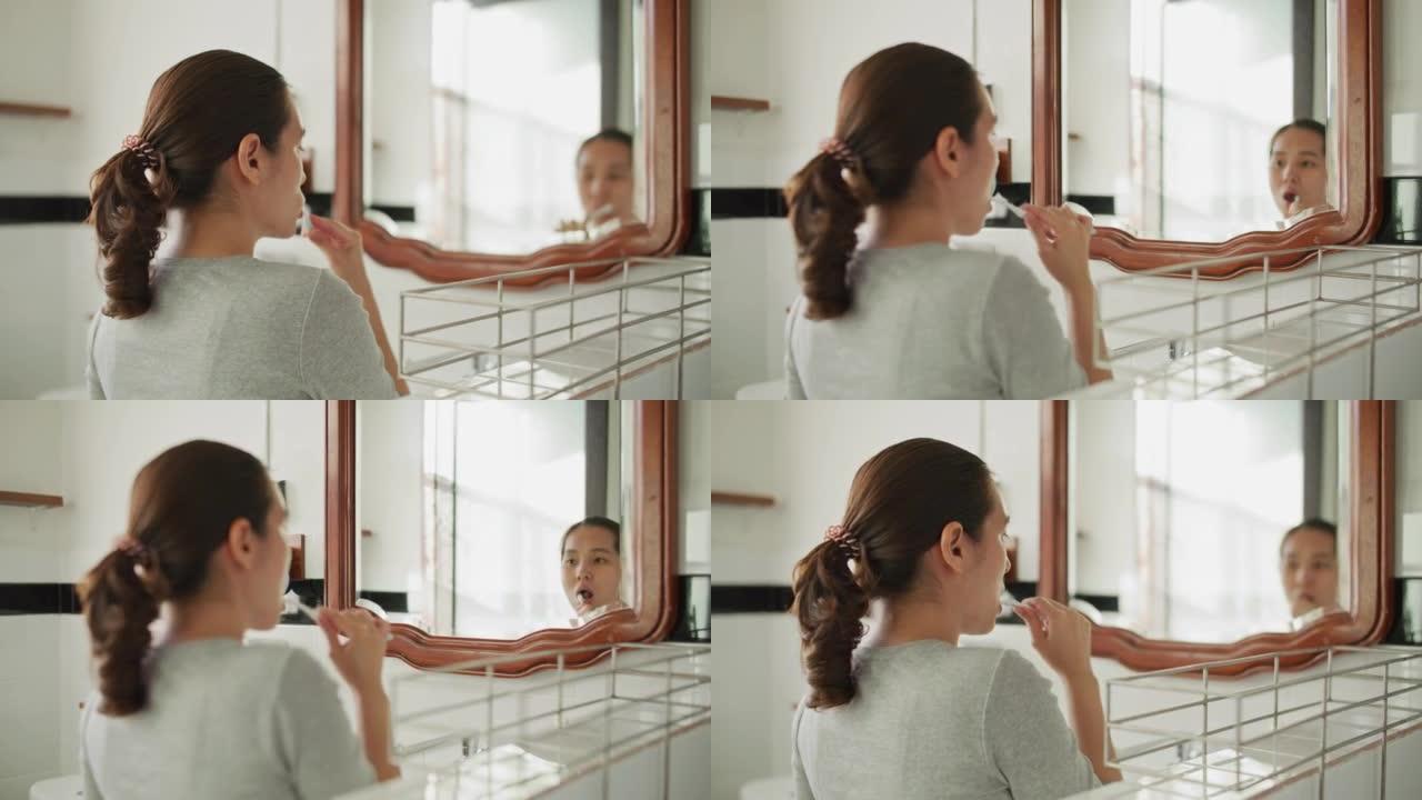 亚洲妇女刷牙梳洗化妆洗漱间上班照镜子