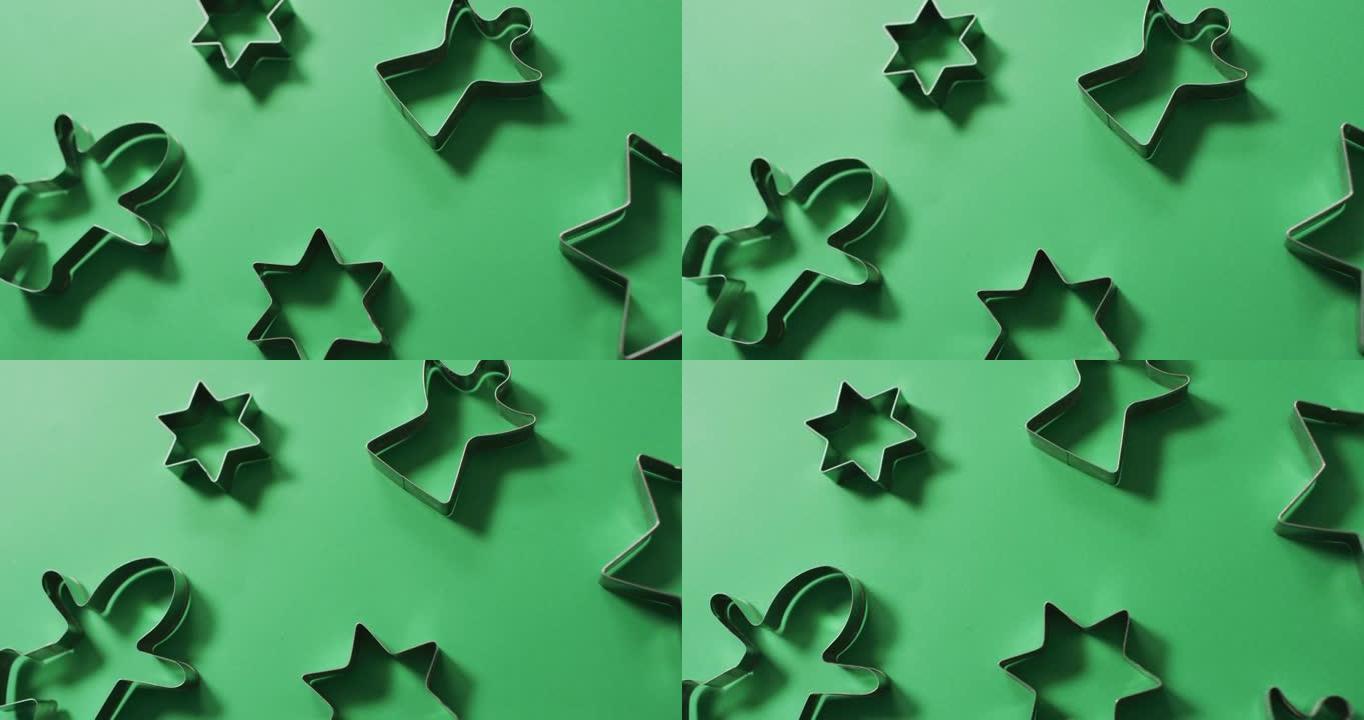 天使，姜饼人和星形饼干切割机和绿色背景上的复制空间