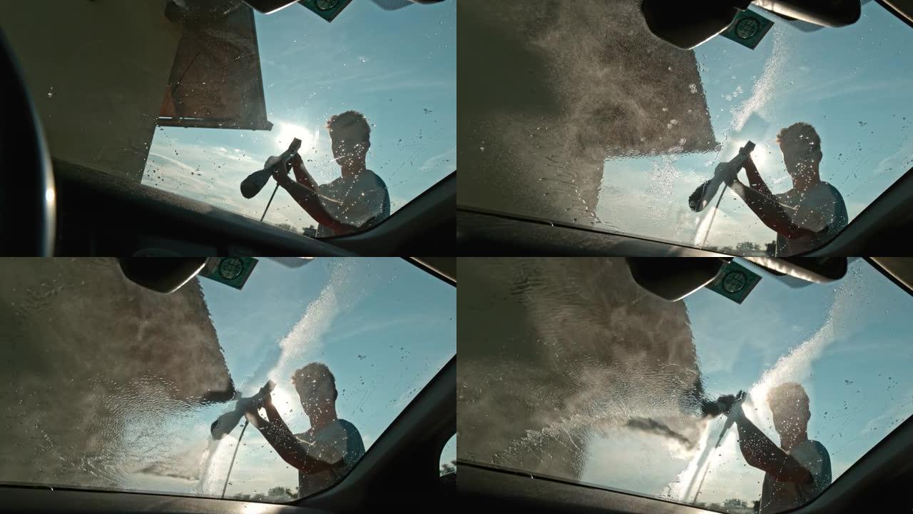 超级SLO MO Man使用压力清洗机在车道上洗车