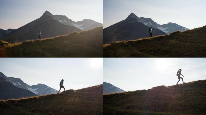 女性徒步旅行者走在山脊小径上，俯瞰下面雄伟的山谷