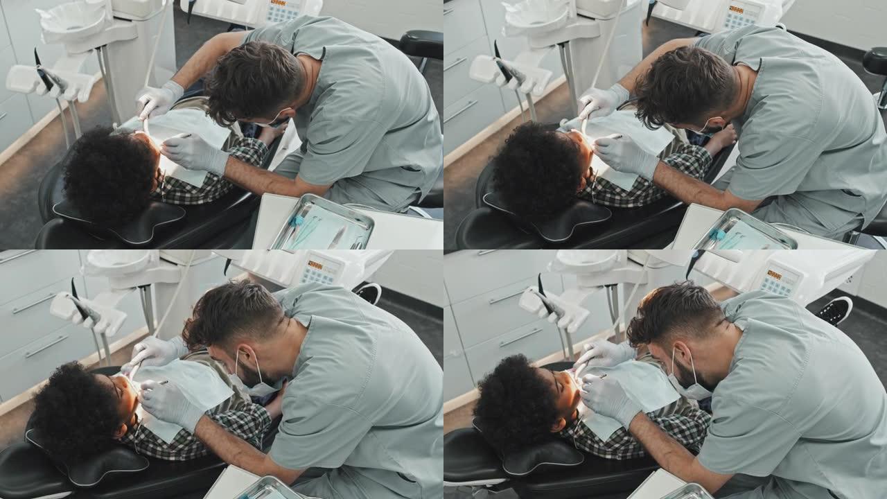 专业牙医治疗男孩的蛀牙