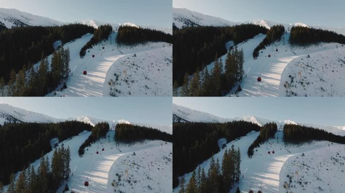 滑雪缆车在美丽的冬季风景山脉度假胜地的斜坡上上下移动，晴天太阳升起。