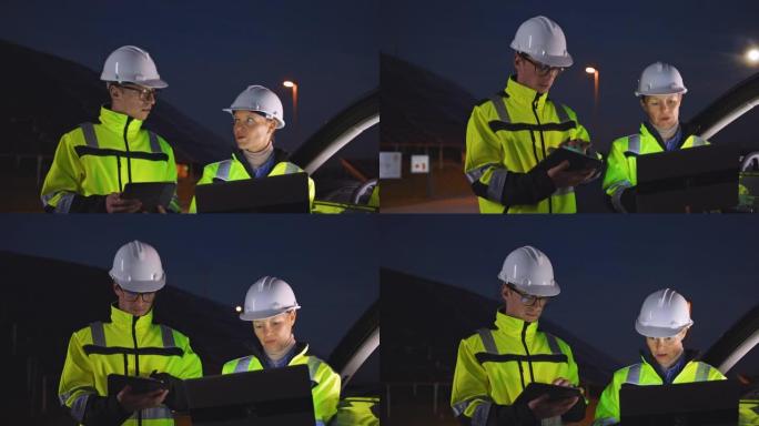 SLO MO现场工程师在夜间使用笔记本电脑检查光伏电站的运行情况
