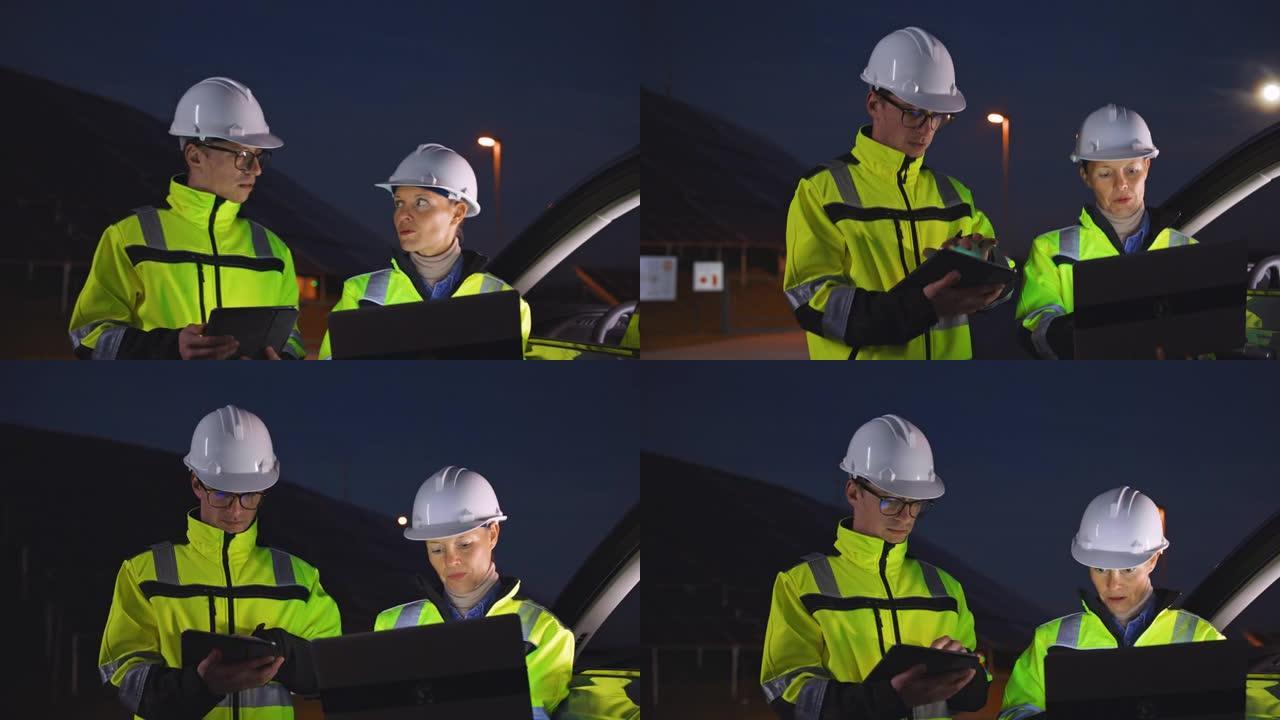 SLO MO现场工程师在夜间使用笔记本电脑检查光伏电站的运行情况