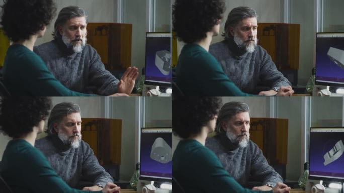 男性同事在计算机上讨论3D细节