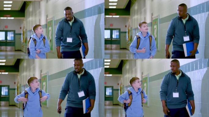 老师与小学生在学校走廊散步