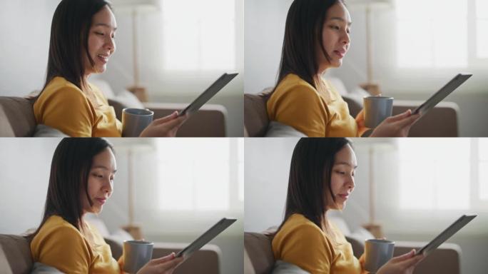亚洲女性在家中使用数字平板电脑