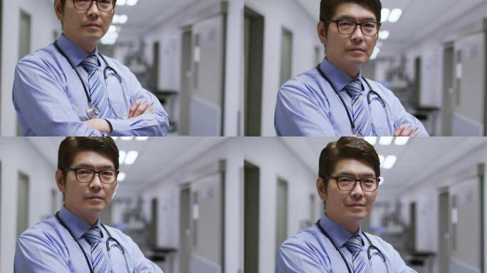 站在医院走廊上的亚洲男医生双臂交叉微笑的肖像