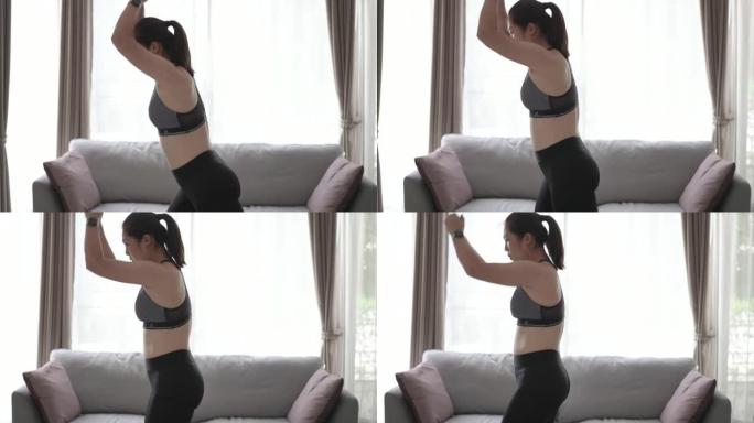 女人在家里的平板电脑上锻炼和练习脂肪燃烧的运动