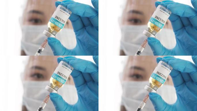 医生或研究人员用口罩握住并填充疫苗到注射器的近手。带口罩的医疗用疫苗填充注射器。Covid19在注射