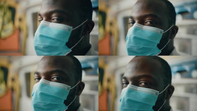 一名黑人非洲裔美国EMS专业护理人员的特写肖像在救护车上戴着安全口罩看着相机。医院外的紧急医疗技术员