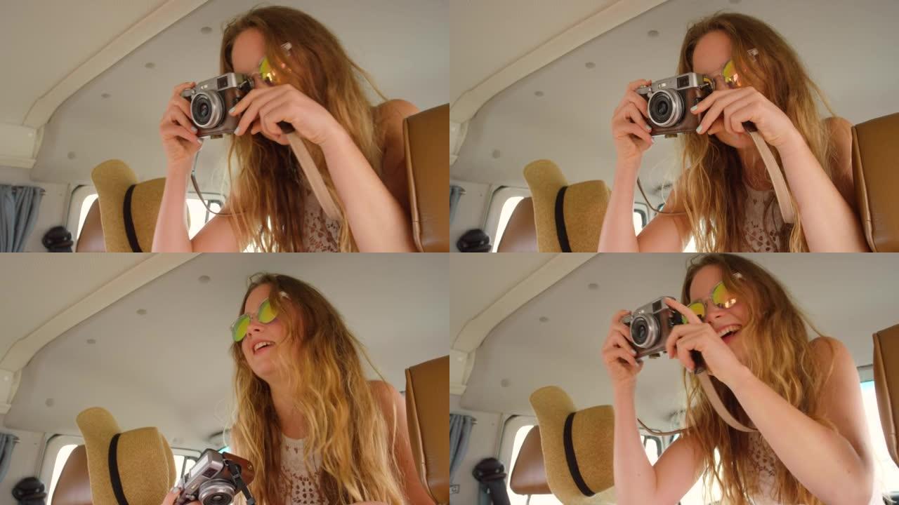 4k视频片段，一位美丽的年轻女性用小型货车的相机拍摄照片
