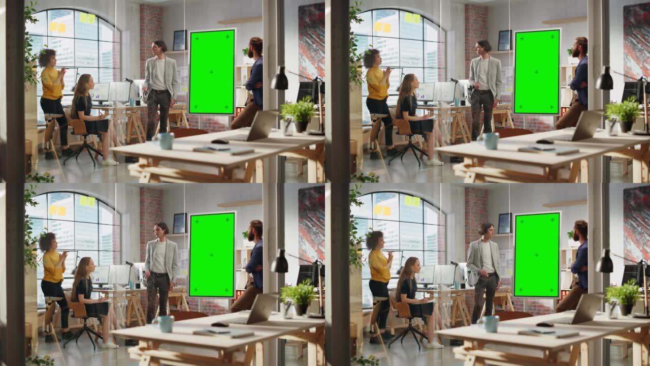 年轻商人在创意办公室会议室领导团队会议。自信时尚的经理在绿屏模拟色度键显示器上展示演示。