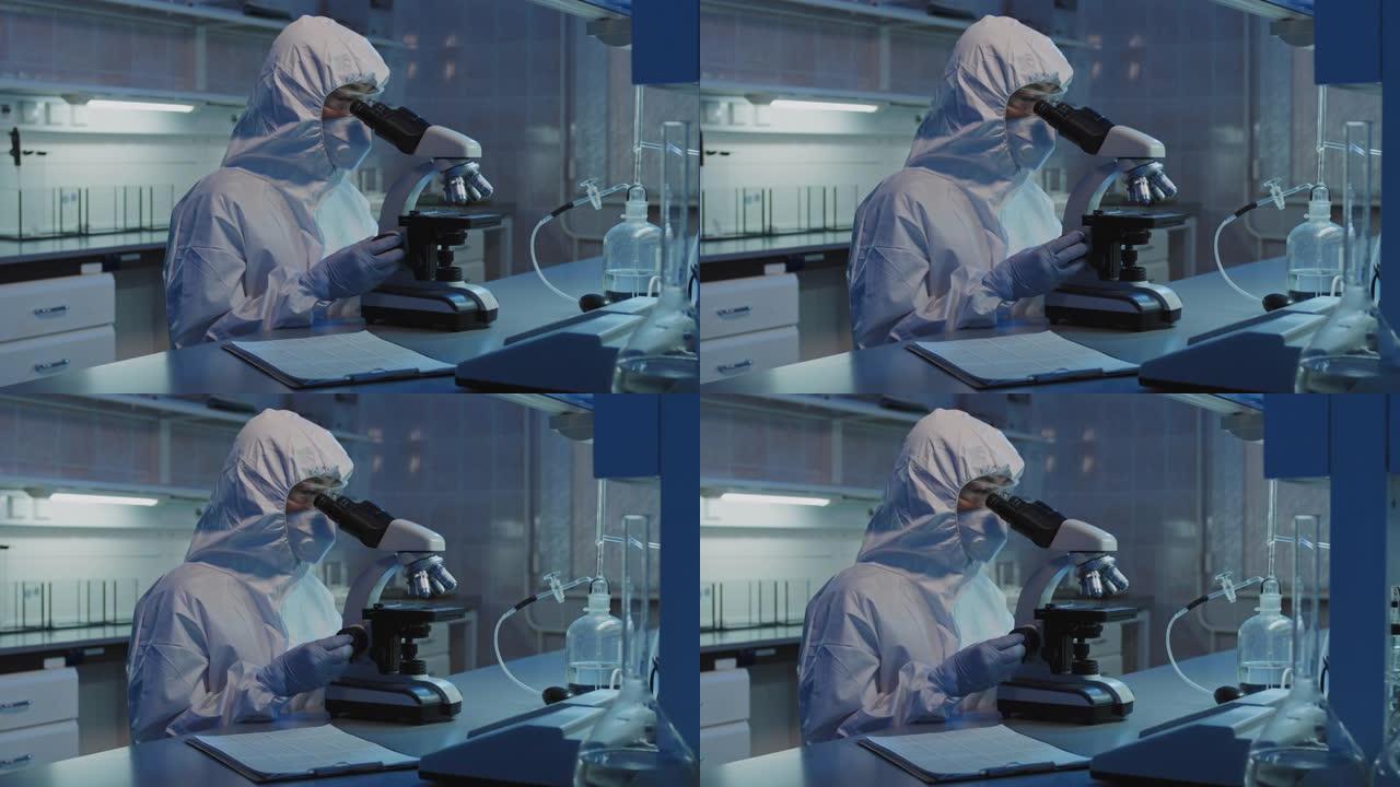 在实验室中使用显微镜进行防护服的流行病学家