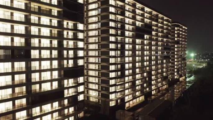 晚上的公寓灯火通明照亮星空玻璃大厦