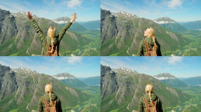4k视频片段，一名年轻女子在Romsdalen周围徒步旅行时欣赏山景