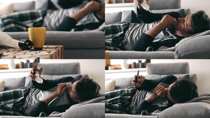 DS男子在家里的沙发上使用智能手机时遭受严重的咳嗽攻击