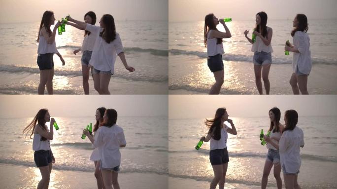 一群女人的幸福和派对在沙滩上与日落和喝酒