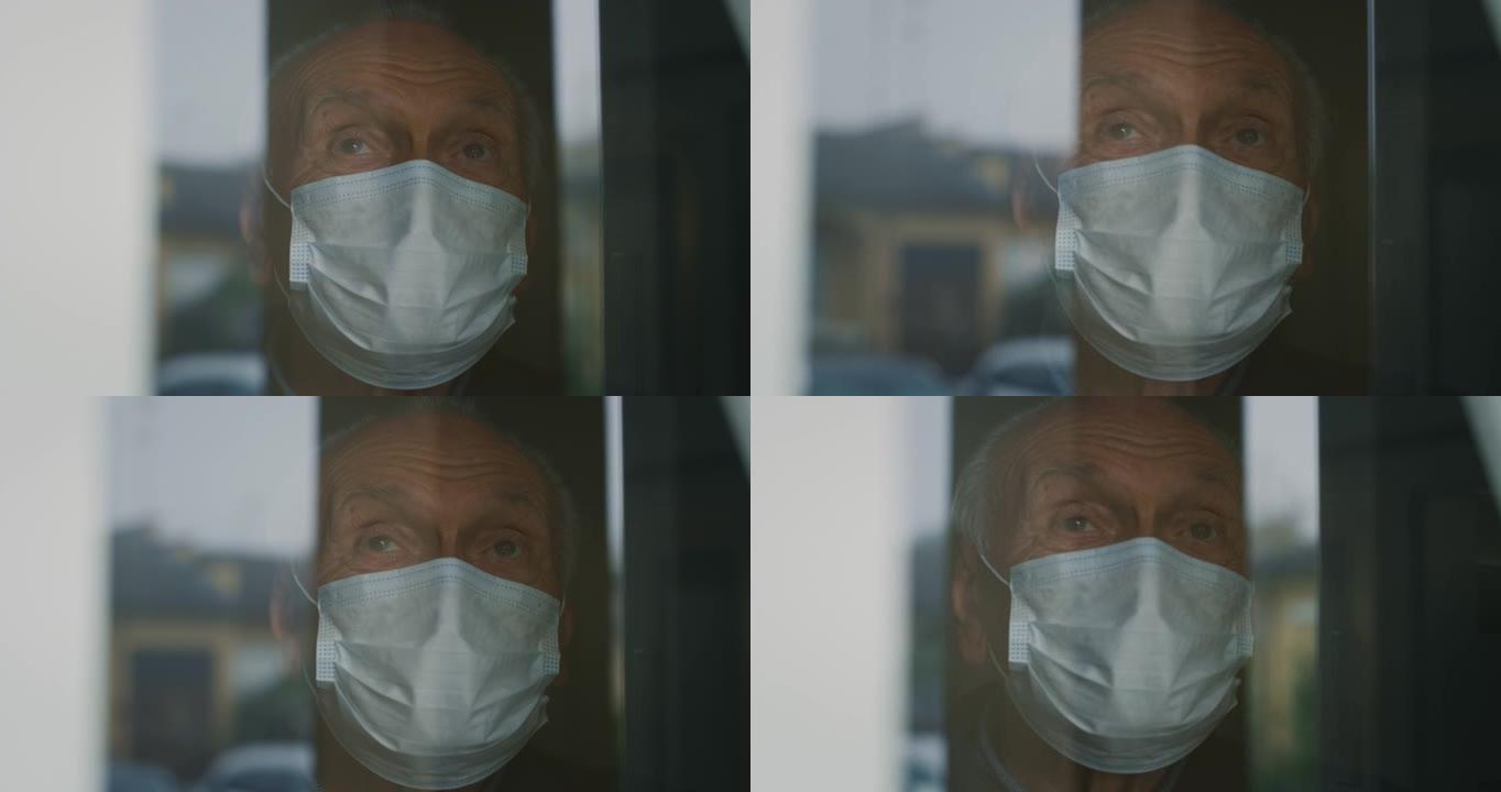电影特写镜头，一个有思想的老人戴着医用防护口罩，正看着窗外。保健、防护、病毒传播、呼吸、隔离、cov