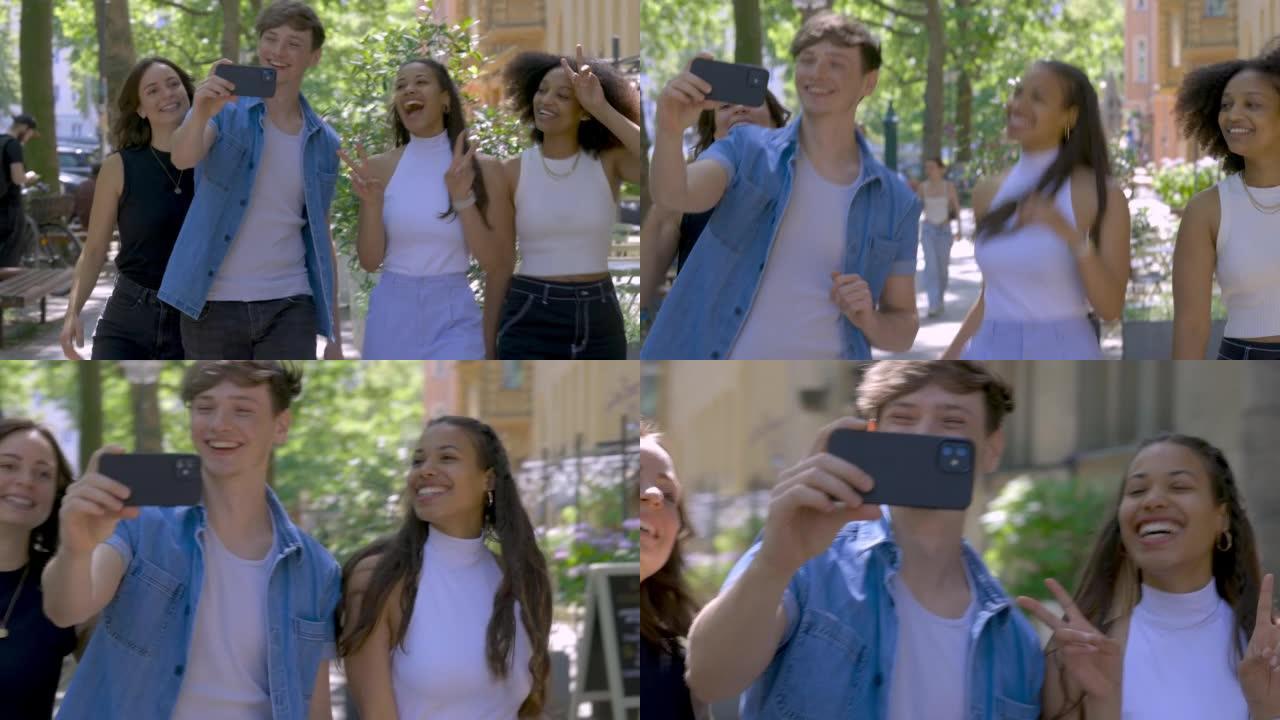 年轻人与女性朋友一起在城市散步并在电话上录制vlog