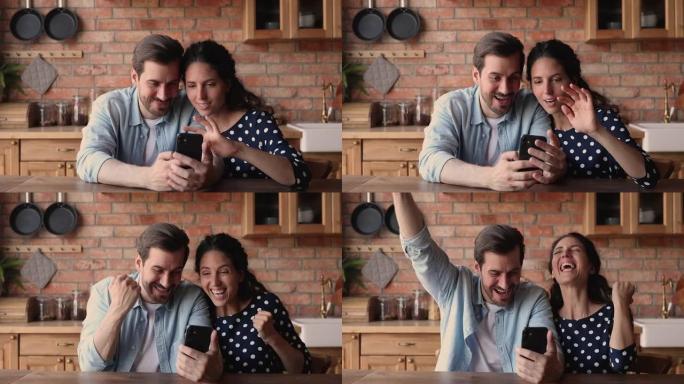 幸福的夫妇在智能手机上阅读短信庆祝在线赌场胜利