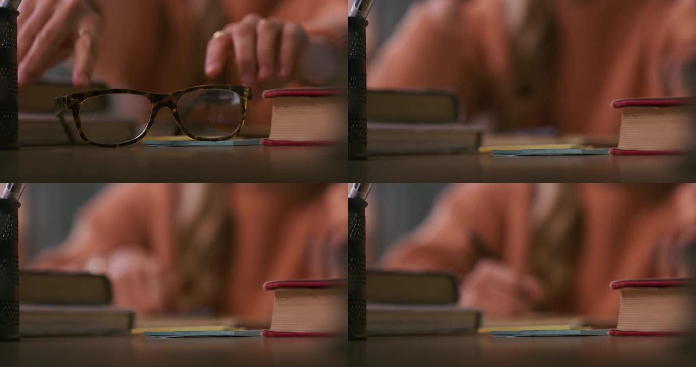 4k视频片段，一名妇女在学习时戴上眼镜