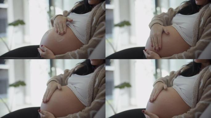 DS无法辨认的妇女在怀孕后期，肚子上有一个心脏符号