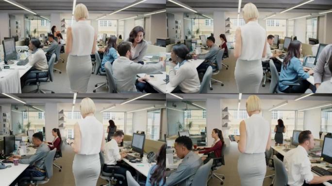 4k视频片段，一个无法识别的女商人走过繁忙的办公室并使用数字平板电脑