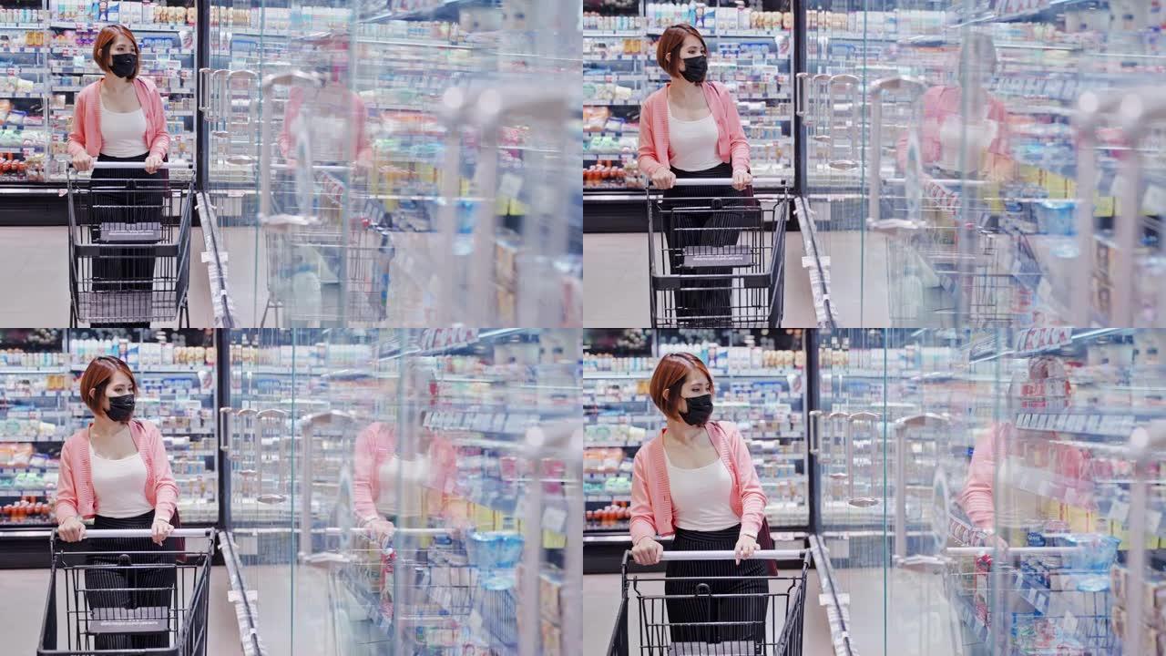 美美的亚洲女子戴着防护口罩在超市商店挑选乳制品