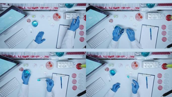 实验室医生的手戴着防护手套，在化学研究过程中拿着带有蓝色液体的试管，我们从高角度看