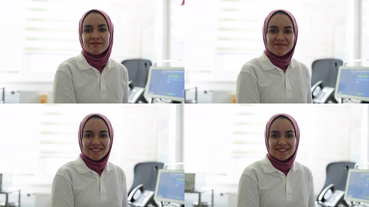 穆斯林女性医生的肖像，戴着头巾坐在诊所
