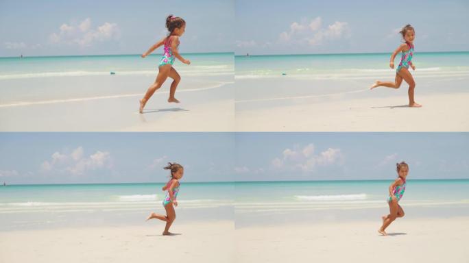 快乐的女孩在沙滩上奔跑