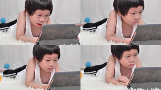 亚洲小男孩5岁在家学习在线课程。