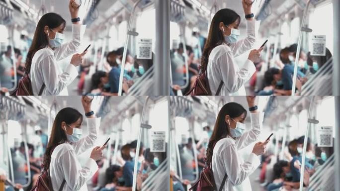在地铁列车上使用智能手机的女人