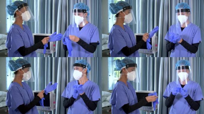 两名护士戴着N95口罩，面罩，戴上手套