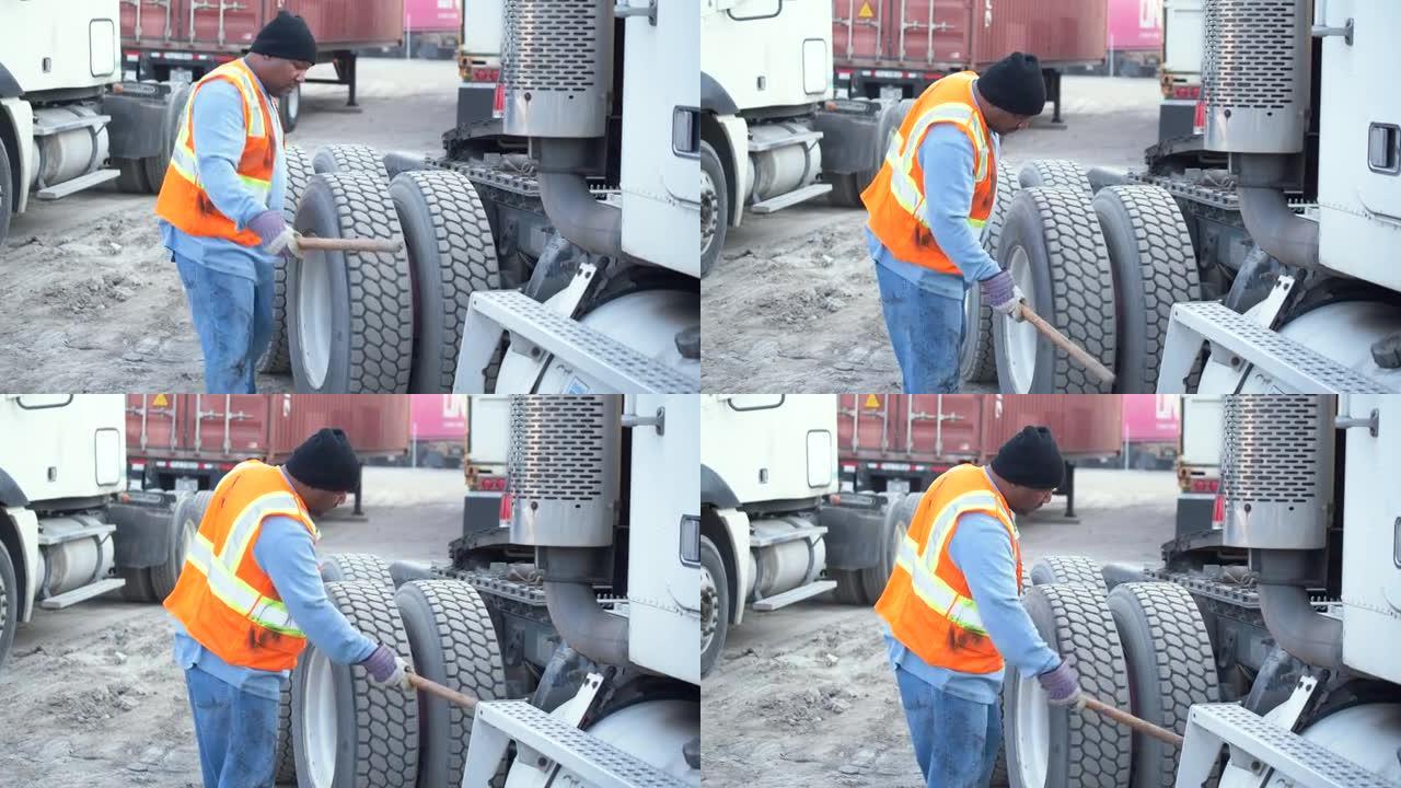 卡车司机检查轮胎是否有合适的气压