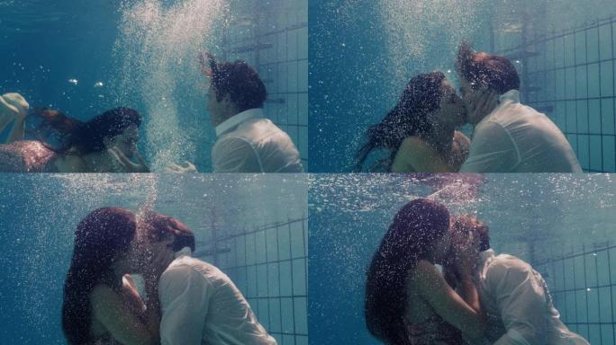 浪漫的情侣在游泳池水下接吻穿着衣服恋爱中的年轻人享受亲密的吻情侣淹没在水中漂浮着热情的亲密