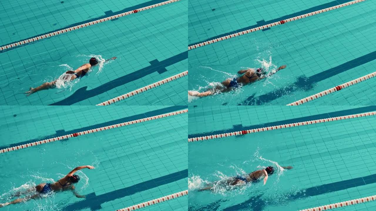 美丽的女游泳者使用前爬行，在游泳池自由泳。立志夺冠的职业运动员。电影慢动作，时尚色彩，艺术高角度跟踪