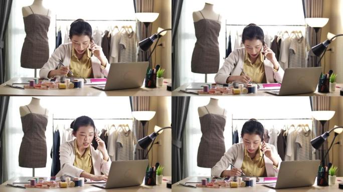 年轻的女性时装设计师或裁缝在她的工作室里通过电话交谈